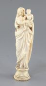 A Continental ivory group of standing Virgin and child, 18th /19th century, on a turned base, height