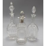 A silver mounted decanter and two other decanters