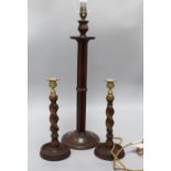 A wooden lamp and a pair of candlesticks