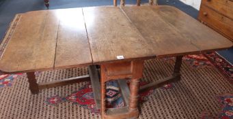 A large 19th century oak drop leaf table, W.168cm