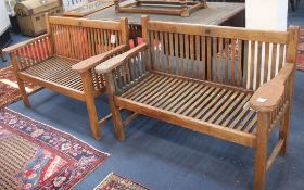 A pair of teak garden benches W.122cm