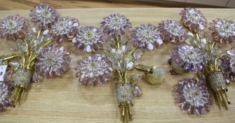 A set of four 20th century amethyst and clear glass five light wall lights designed as sprays of