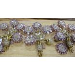 A set of four 20th century amethyst and clear glass five light wall lights designed as sprays of