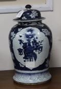 A pair of Chinese blue and white vases and covers decorated with prunus blossom