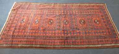 An Afghan rug, woven six central panels, 180cm x 95cm