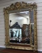 A Victorian carved giltwood and gesso wall mirror, H.140cm