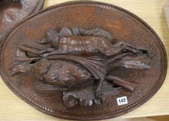 A pair of carved wood plaques