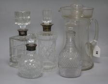 A large lemonade jug, three silver mounted decanters and another