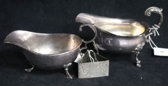 Two silver sauceboats and a silver triangular napkin ring. 10.5 oz.
