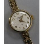 A lady's 9ct gold Majex manual wind wrist watch on a 9ct gold bracelet.