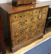 A walnut chest of drawers incorporating William III bird and floral marquetry drawers, W.94cm