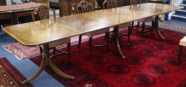 A Regency style mahogany extending pedestal dining table and two spare leaves, W.386cm