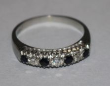 An 18ct white gold, sapphire and diamond half hoop ring, size M.