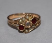 A yellow metal, ruby and split pearl ring (one stone missing), size H.