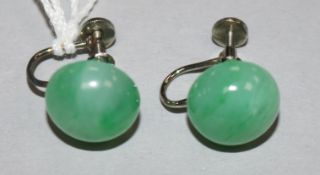 A pair of cabochon jadeite ear clips with certificate.