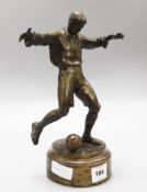 A bronze figure of a footballer