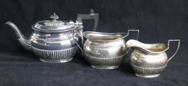 An Edwardian demi fluted silver three piece bachelor's tea set, Richard Richardson, Sheffield,