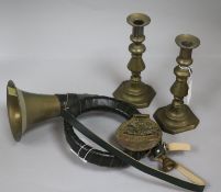 A pair of brass candlesticks, a horse brass and a hunting horn