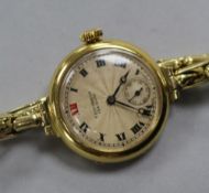 An early 20th century 18ct gold manual wind wrist watch retailed by T.s. Cuthbert, Glasgow, on