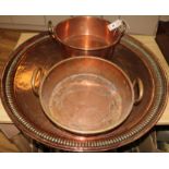 A Victorian copper two handled preserving pan and a large copper tray