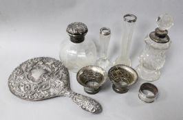 A silver-mounted glass toilet bottle, engraved with scrolling knapweed, William Comyns and sundry