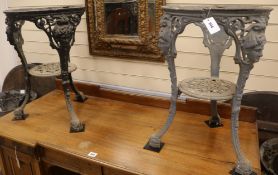 A set of four cast iron base circular pub tables, H.67cm