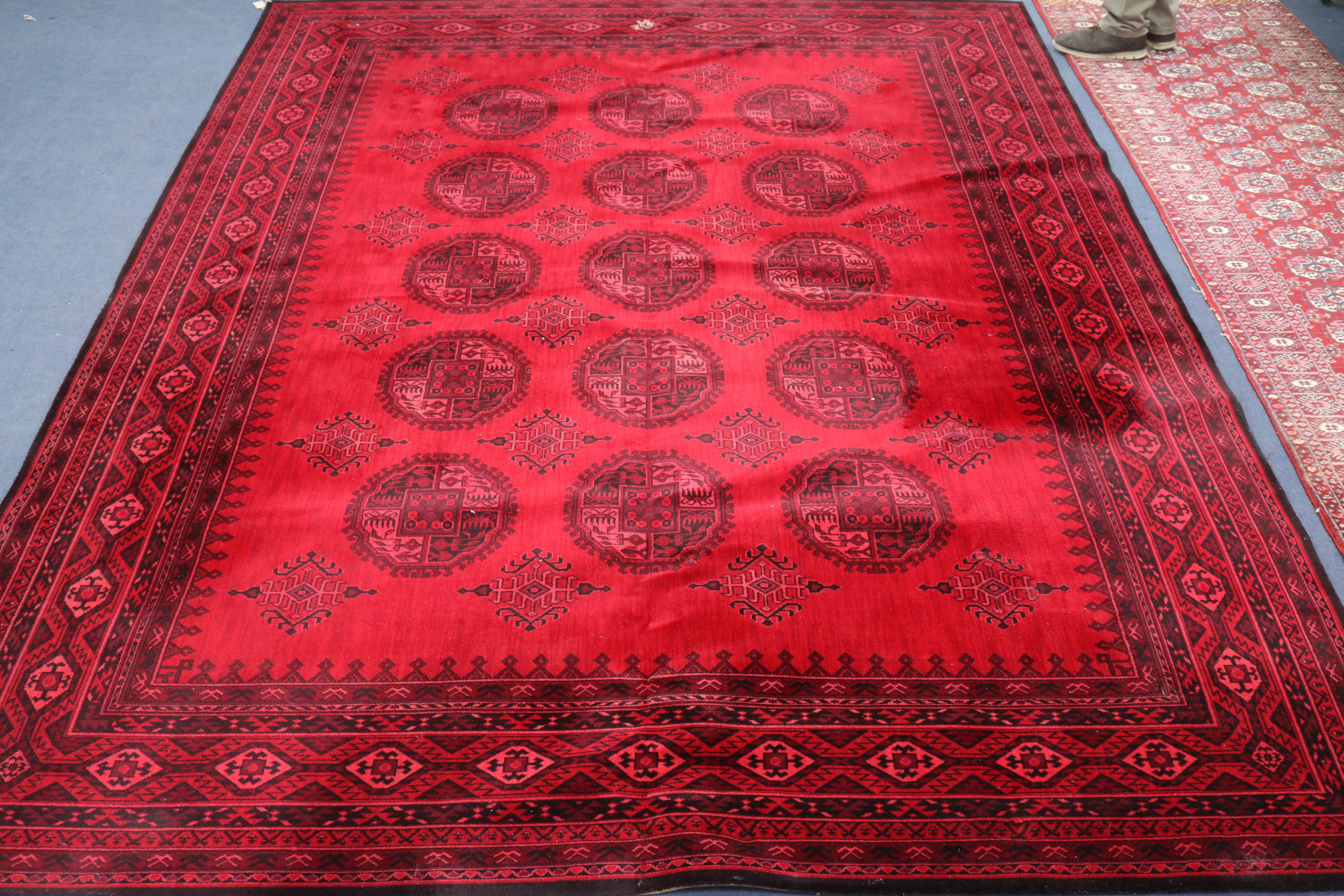 A Bokhara red ground carpet (worn) 366 by 276cm