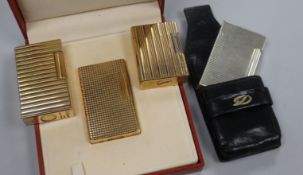 Four assorted Dupont lighters, including three gilt metal (one with box) and one silver plated.