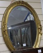 A gilt oval wall mirror, H.83cm