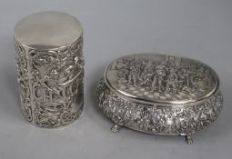 A Dutch silver oval box and a similar cylindrical box, each with hinged cover, one embossed with the