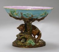 A George Jones majolica comport, the pedestal modelled as a tree trunk with a fox chasing a