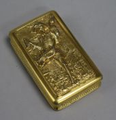 A 19th century gilt metal box with a relief image of a peddler