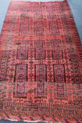 A Baluchi red and blue ground rug, 220 x 125cm