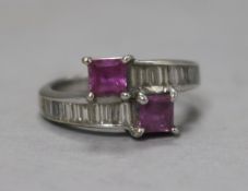 An 18ct white gold pink sapphire and baguette cut diamond crossover ring, 6g gross