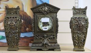 An ornate brass clock garniture