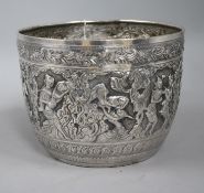A Burmese large white metal bowl, embossed with bands of dancing figures, foliage, etc. 24.5oz h.
