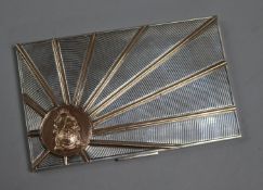 An Art Deco style white metal and gilt engine-turned cigarette case, with gilt sunburst motif