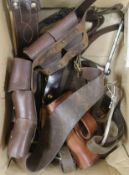 A group of leather bridles, stirrups and leather ammunition pouches