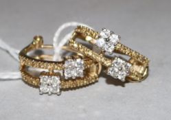 A pair of 14ct gold and diamond stud earrings, each with 8 small diamonds in offset square settings,