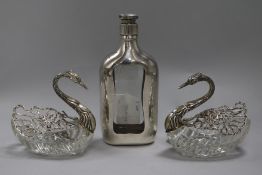 A pair of sterling silver-mounted (925) cut glass 'swan' bon bon dishes and a glass spirit flask