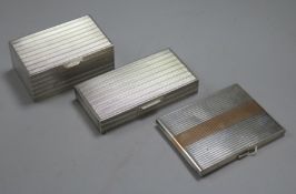 Two engine-turned white metal cigarette boxes (one marked 'S. L. Silver') and a similar gilt-