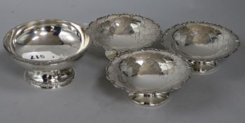 A Goldsmiths & Silversmiths Co. Ltd silver pedestal bowl with cast decoration and a set of three