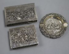 Two Dutch silver cedar-lined cigarette boxes and a circular silver ashtray, the boxes embossed