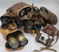 A quantity of binoculars and a camera