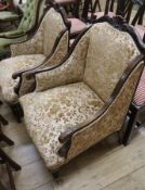 A pair of late Victorian mahogany upholstered armchairs