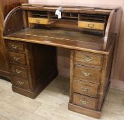 An oak roll top desk, W.122cm