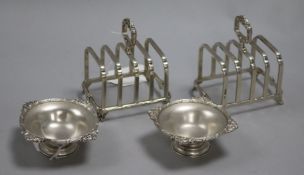 A pair of Mappin & Webb silver toast racks and a pair of satin silver small pedestal dishes, the