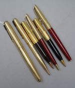 A Parker 51 14K gold-plated pen and pencil set, a Waterman pen and pencil set and two small Waterman