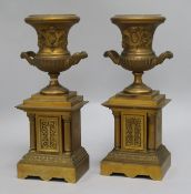 A pair of bronze urns on stand