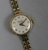 A lady's 9ct gold Majex manual wind wrist watch on a 9ct gold bracelet.